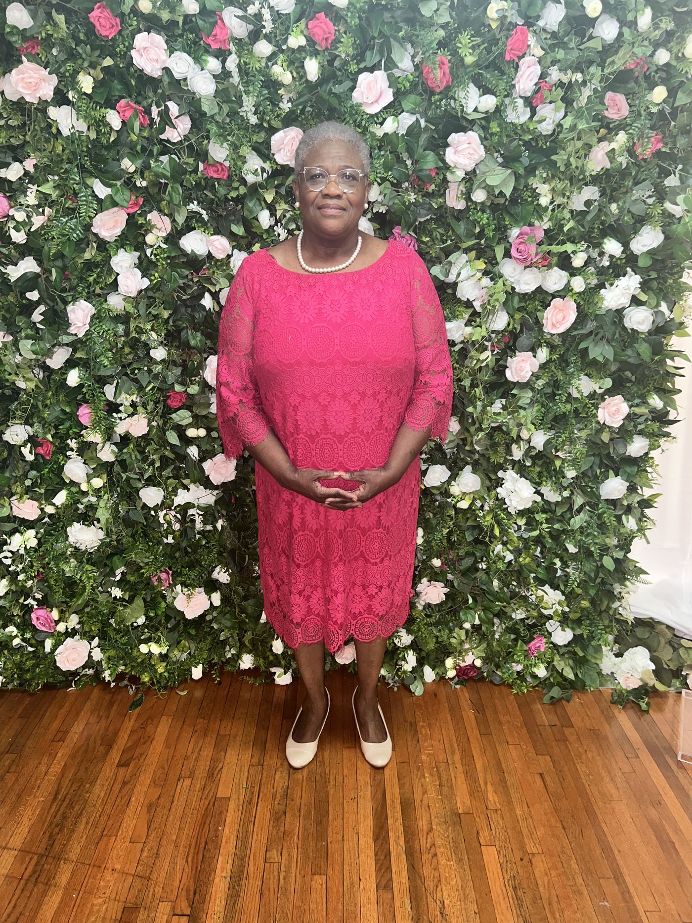 Guest posing at the floral wall