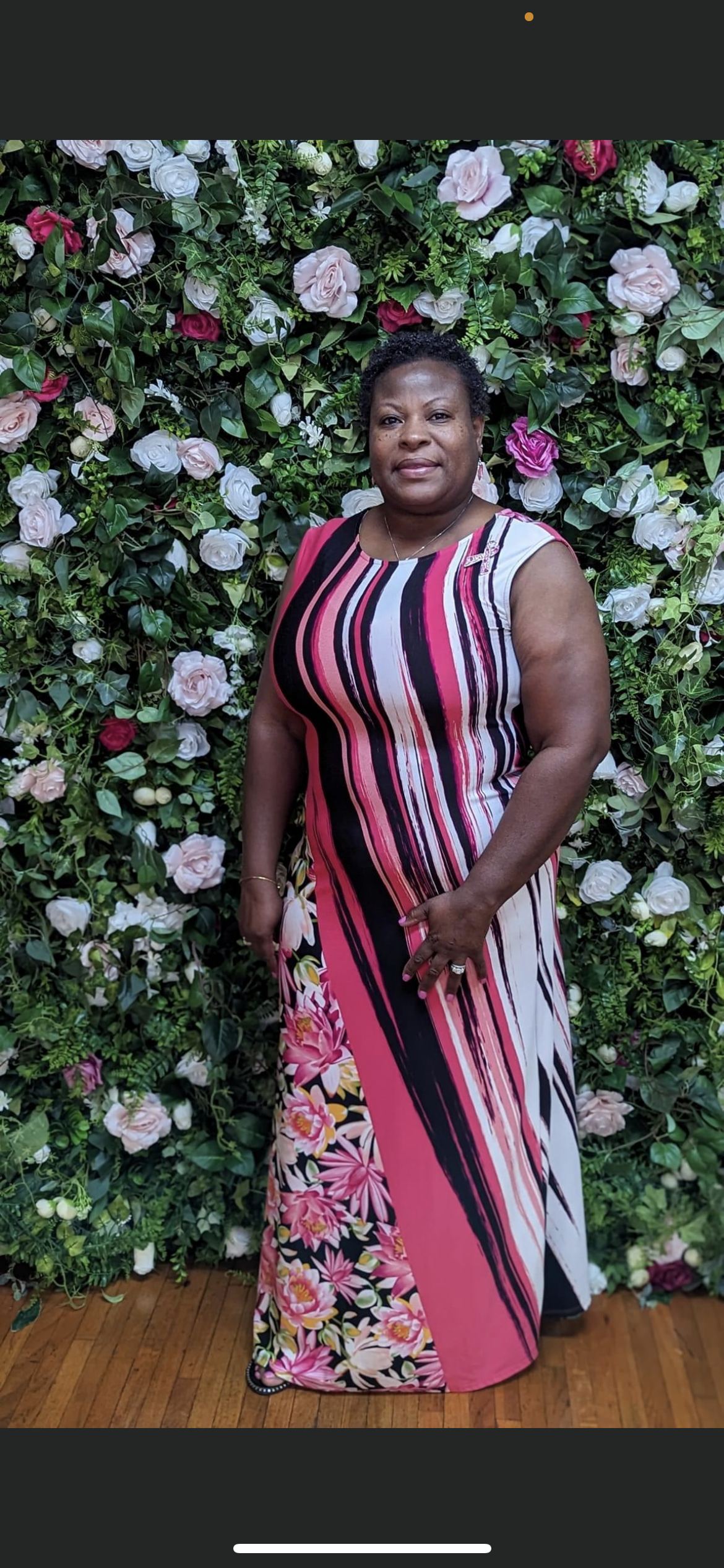 Survivor posing at the floral wall