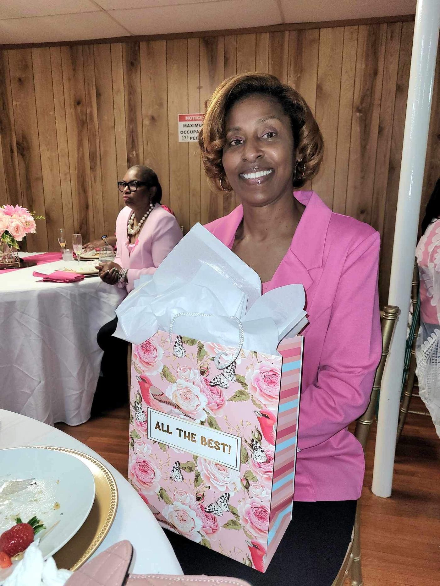 Guest holding a gift bag at the luncheon